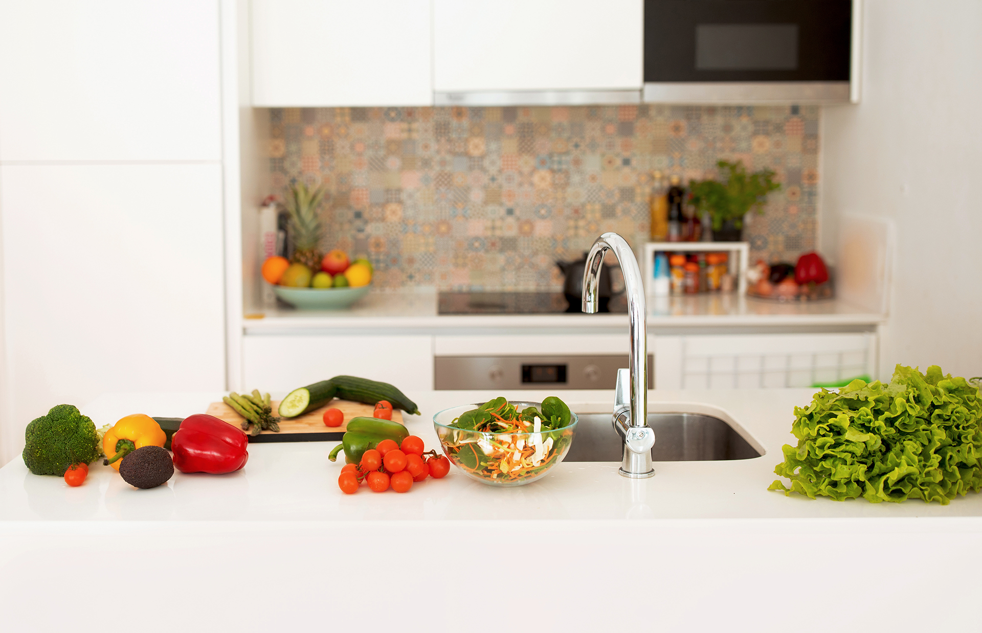 Cooking Healthy Food. Interior Of Modern Kitchen With Grocery Products And Fresh Vegetables On A Countertop Table With Sink Indoors. Culinary Recipes And Dinner Preparation Concept. No People